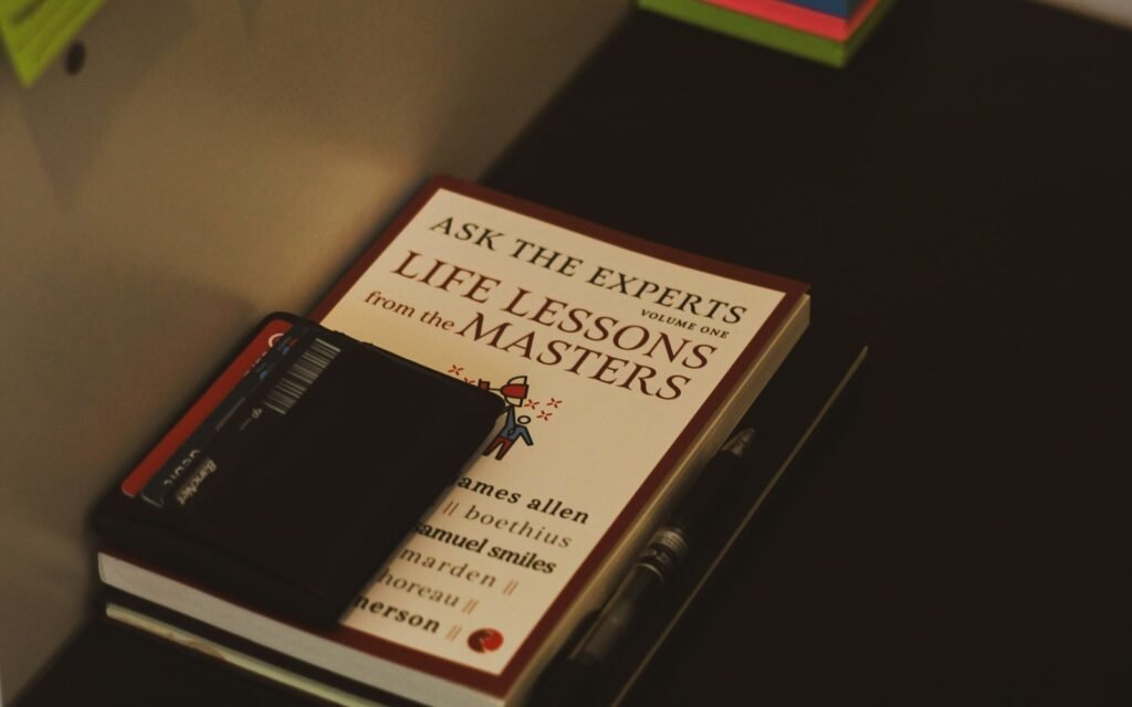 Books, a notebook and colorful notes arranged on a quiet editorial desk.